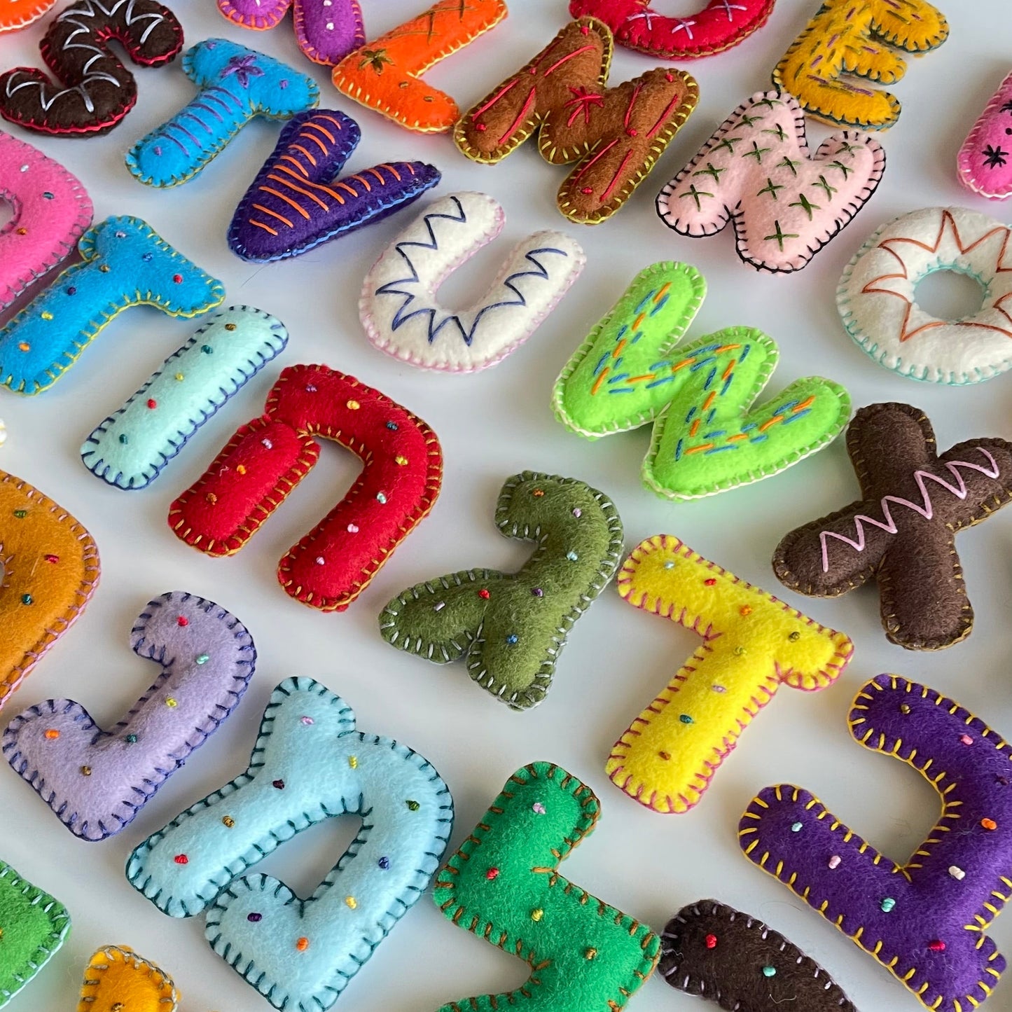Colorful felt letters on a white background