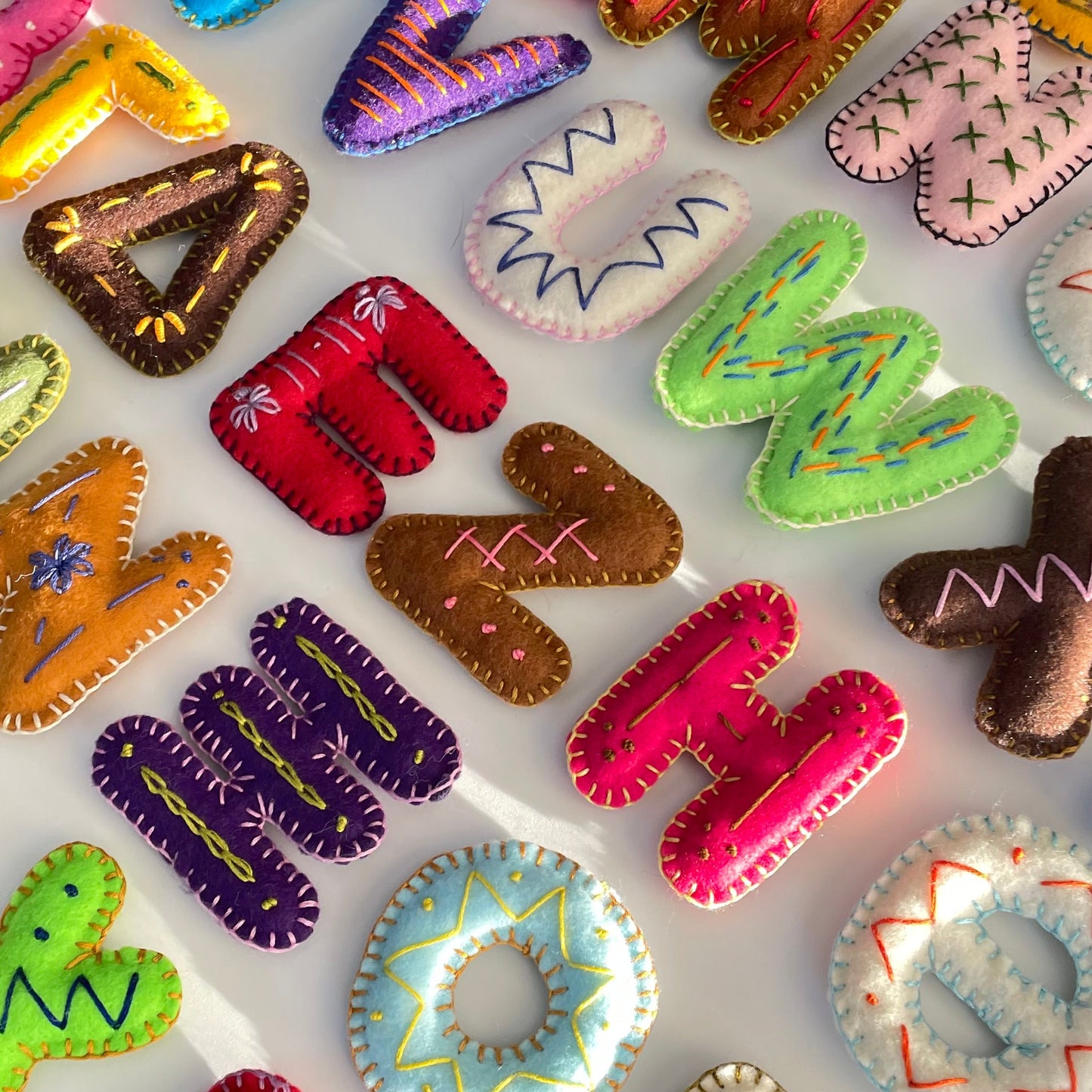 Colorful alphabet letter-shaped toys on a white background